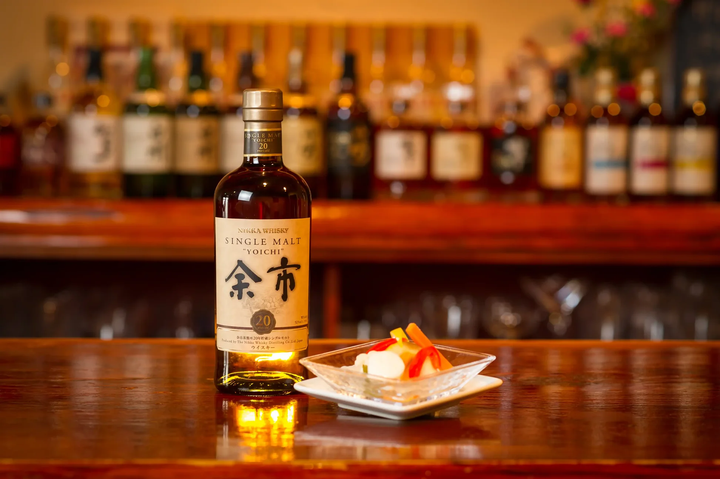 Yoichi whisky bottle and glasses on a bar counter