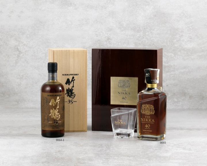 Collectible whisky bottles with a tasting glass and wooden boxes