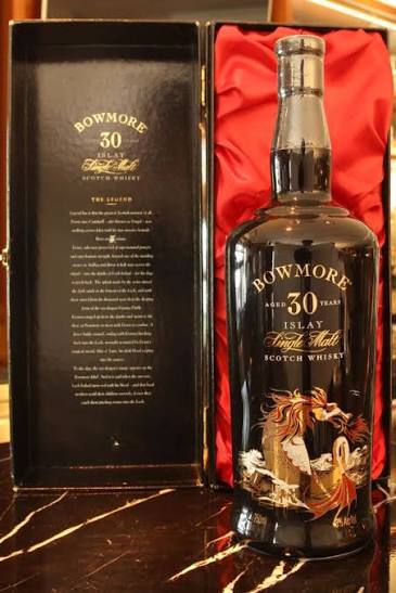 Bowmore 50 Year Old bottle with a gold label and a black and red presentation case