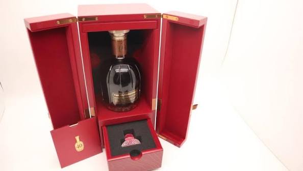 The Glenrothes Aqua Collection bottle inside an open red presentation chest